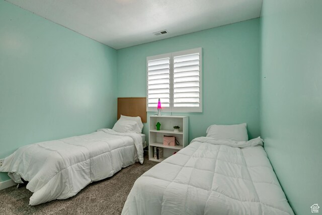bedroom with visible vents and carpet floors