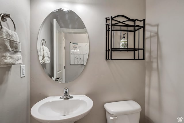 bathroom with toilet and a sink