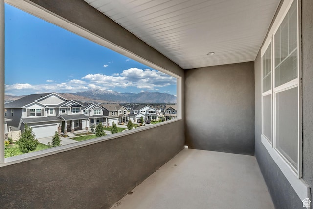 balcony with a residential view and a mountain view