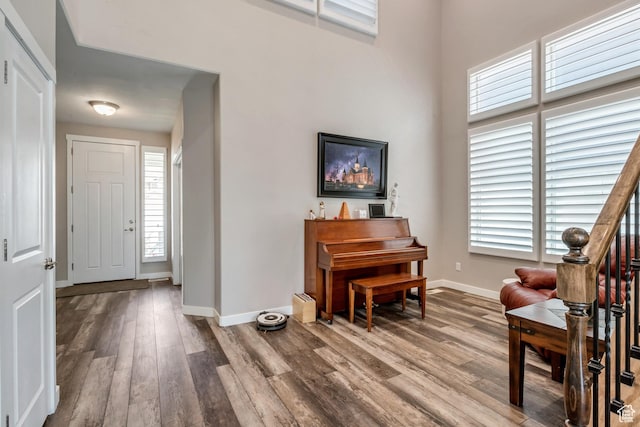foyer featuring baseboards and wood finished floors