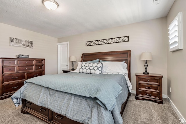 bedroom with baseboards and light colored carpet