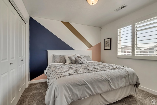 carpeted bedroom with baseboards, visible vents, and a closet