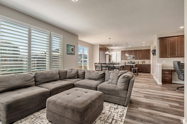 living area featuring recessed lighting and light wood-style floors