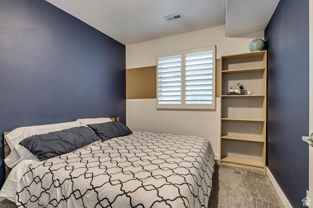 bedroom with baseboards, visible vents, and carpet floors