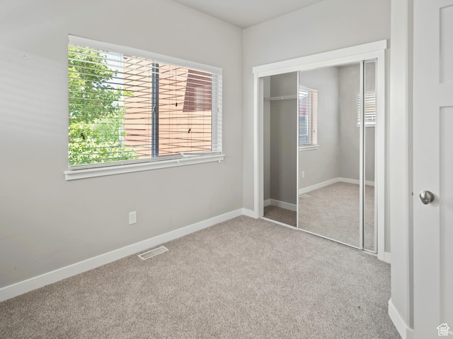 1138 N Shepard Creek Pkwy W Unit 2, Farmington, UT 84025 - unfurnished bedroom with carpet flooring, multiple windows, a closet, and baseboards