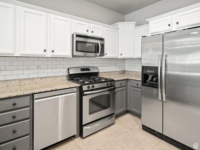 1138 N Shepard Creek Pkwy W Unit 2, Farmington, UT 84025 - kitchen with stainless steel appliances, gray cabinets, white cabinets, decorative backsplash, and light tile patterned flooring