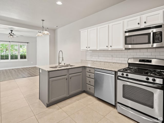 1138 N Shepard Creek Pkwy W Unit 2, Farmington, UT 84025 - kitchen featuring appliances with stainless steel finishes, a sink, gray cabinets, a peninsula, and white cabinetry