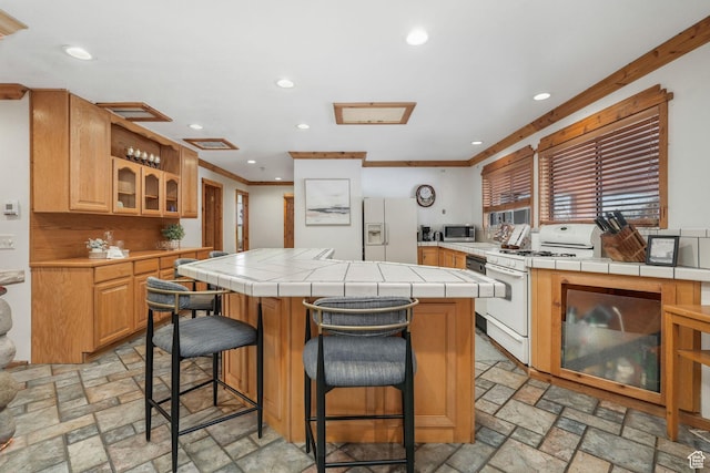 3640 E Aurora Cir, Salt Lake City, UT 84124 - kitchen with stone tile flooring, white appliances, a kitchen island, and tile countertops