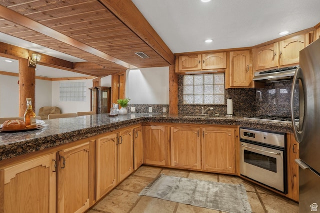 3640 E Aurora Cir, Salt Lake City, UT 84124 - kitchen with stone tile floors, dark countertops, decorative backsplash, appliances with stainless steel finishes, and under cabinet range hood