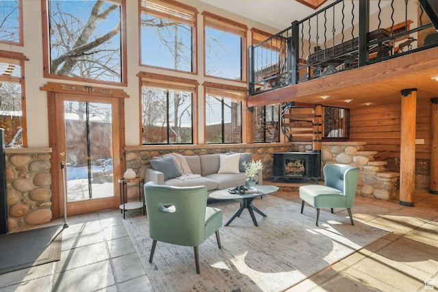3640 E Aurora Cir, Salt Lake City, UT 84124 - living area with a stone fireplace, stone tile flooring, and a towering ceiling