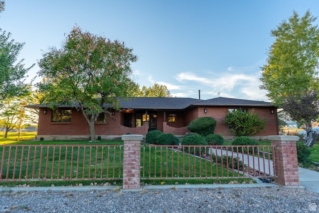 452 S 100 W, Salina, UT 84654 - single story home featuring brick siding, a fenced front yard, and a front lawn