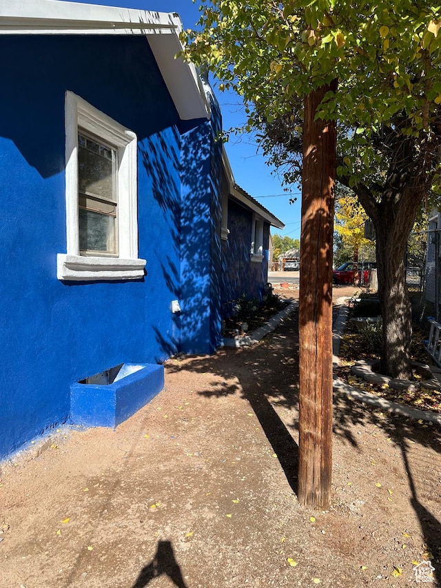 view of side of home with stucco siding