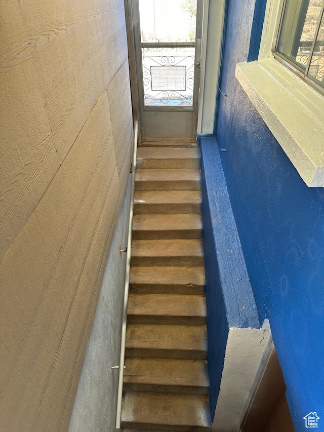stairway featuring plenty of natural light