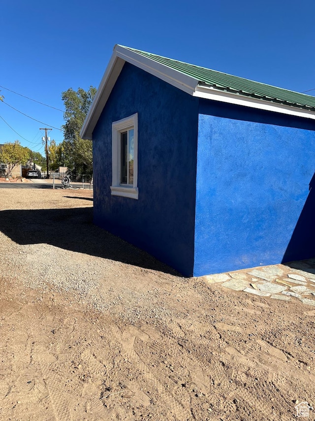 view of home's exterior featuring stucco siding and metal roof