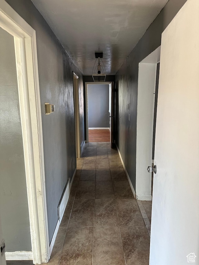 corridor featuring baseboards and visible vents