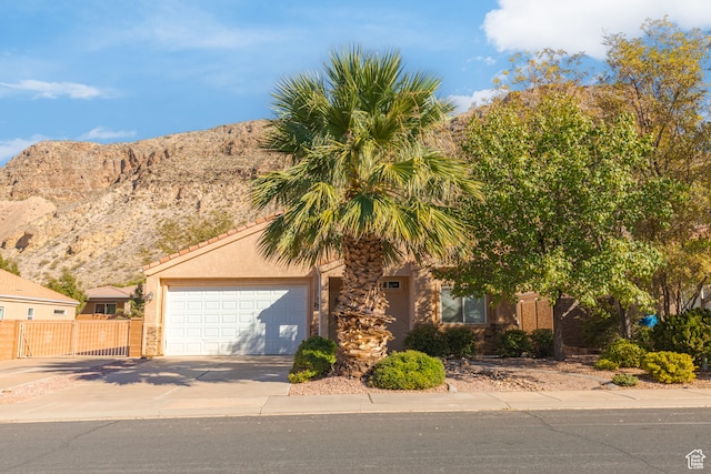 view of front facade with a mountain view and a garage