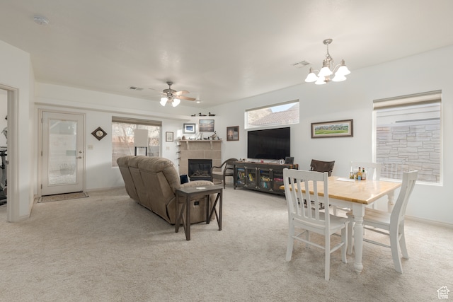 2331 S 675 W, Hurricane, UT 84737 - dining space with light carpet, a tile fireplace, and ceiling fan with notable chandelier