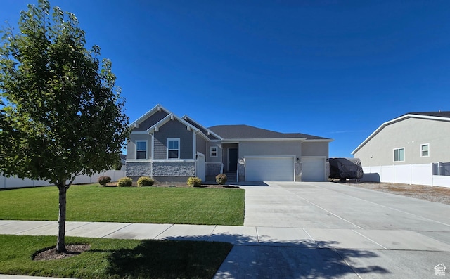 697 N 3275 W, Layton, UT 84041 - craftsman-style home featuring stone siding, an attached garage, and driveway
