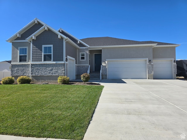 view of front of property featuring a front yard and a garage