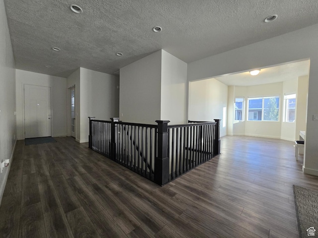 697 N 3275 W, Layton, UT 84041 - hallway featuring an upstairs landing, dark wood-style flooring, a textured ceiling, and recessed lighting