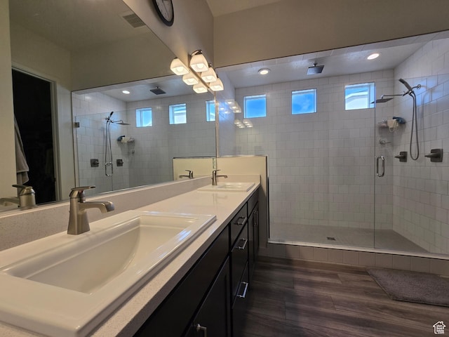 697 N 3275 W, Layton, UT 84041 - full bathroom featuring a shower stall, double vanity, wood finished floors, and healthy amount of natural light