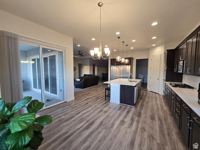 697 N 3275 W, Layton, UT 84041 - kitchen featuring open floor plan, a chandelier, stainless steel appliances, dark wood-style floors, and recessed lighting