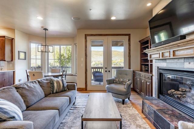3126 Lower Saddleback Rd, Park City, UT 84098 - living area featuring recessed lighting, a tiled fireplace, light wood finished floors, and french doors