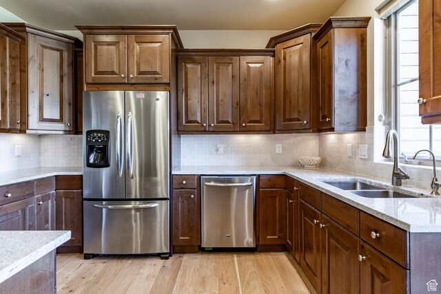 3126 Lower Saddleback Rd, Park City, UT 84098 - kitchen featuring light stone counters, tasteful backsplash, a sink, stainless steel appliances, and light wood finished floors