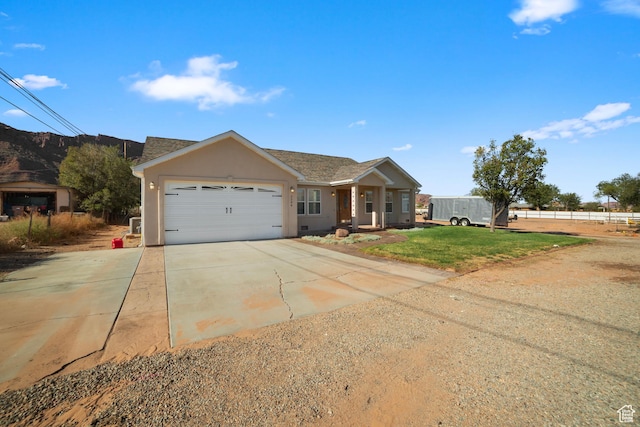 ranch-style house with driveway, a garage, and stucco siding
