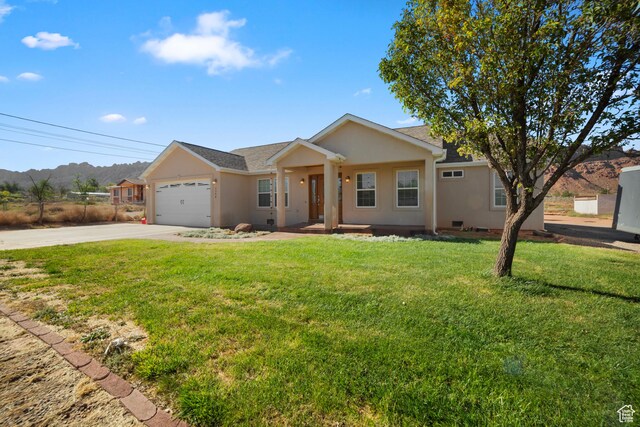 2304 Spanish Valley Dr, Moab, UT 84532 - single story home with driveway, stucco siding, a garage, and a front lawn
