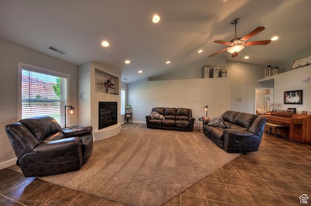 living area featuring lofted ceiling, ceiling fan, recessed lighting, dark tile patterned floors, and a fireplace