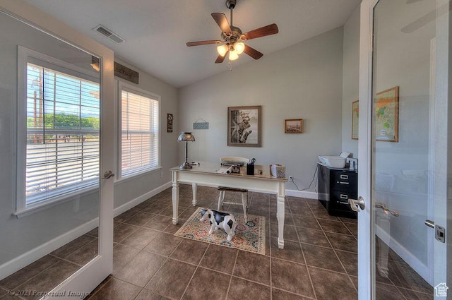 office featuring lofted ceiling, baseboards, a ceiling fan, and dark tile patterned floors