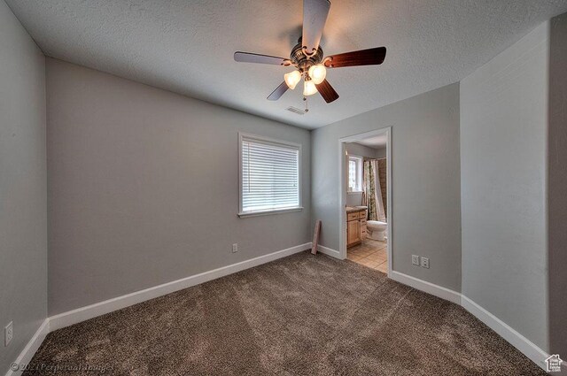 2304 Spanish Valley Dr, Moab, UT 84532 - spare room featuring light carpet, a ceiling fan, a textured ceiling, and baseboards