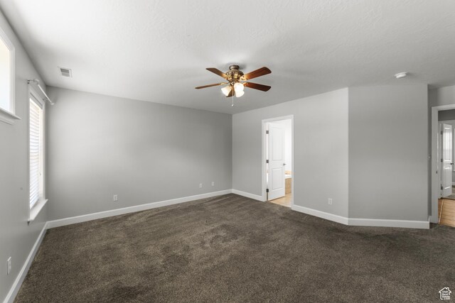 2304 Spanish Valley Dr, Moab, UT 84532 - unfurnished bedroom featuring carpet flooring, baseboards, ensuite bath, and ceiling fan