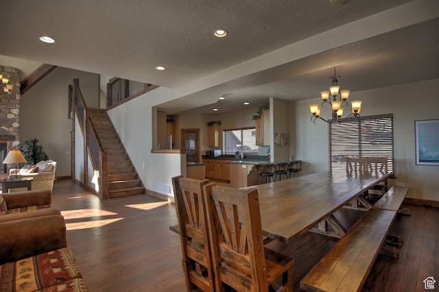 21 Gentle Ben Cir, Fish Haven, ID 83287 - dining room featuring a textured ceiling, dark hardwood / wood-style floors, and an inviting chandelier