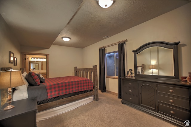 21 Gentle Ben Cir, Fish Haven, ID 83287 - bedroom featuring light carpet, a textured ceiling, and ensuite bath