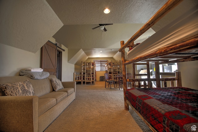 21 Gentle Ben Cir, Fish Haven, ID 83287 - carpeted bedroom featuring lofted ceiling, a barn door, and a textured ceiling