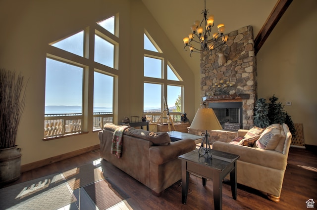 21 Gentle Ben Cir, Fish Haven, ID 83287 - living room with dark wood-type flooring, a stone fireplace, and a high ceiling