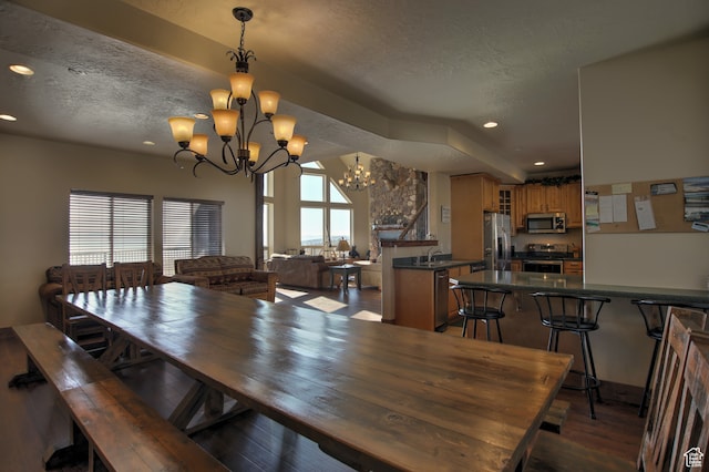21 Gentle Ben Cir, Fish Haven, ID 83287 - dining room featuring a notable chandelier, a textured ceiling, sink, and dark hardwood / wood-style flooring