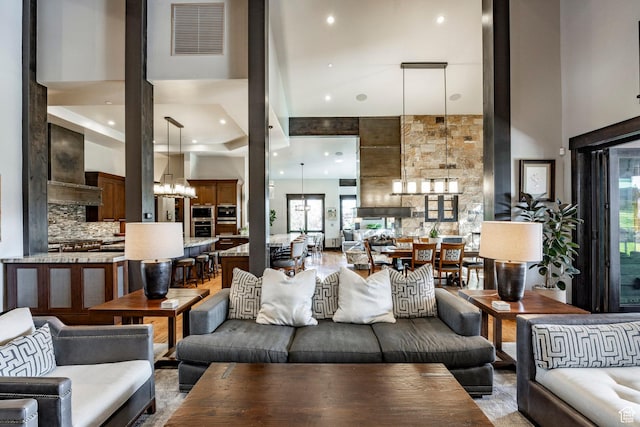 1159 Snow Berry St, Park City, UT 84098 - living area with a notable chandelier, a healthy amount of sunlight, visible vents, and a towering ceiling