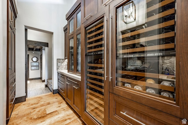 1159 Snow Berry St, Park City, UT 84098 - bar with light wood-style flooring, baseboards, and backsplash