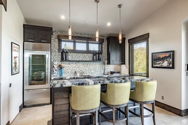 1159 Snow Berry St, Park City, UT 84098 - kitchen featuring a kitchen breakfast bar, baseboards, decorative backsplash, built in fridge, and recessed lighting