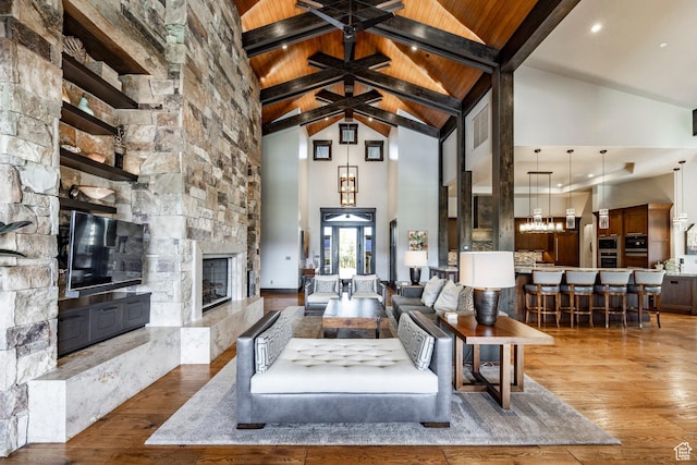 1159 Snow Berry St, Park City, UT 84098 - living room with wood ceiling, wood finished floors, high vaulted ceiling, beamed ceiling, and a stone fireplace