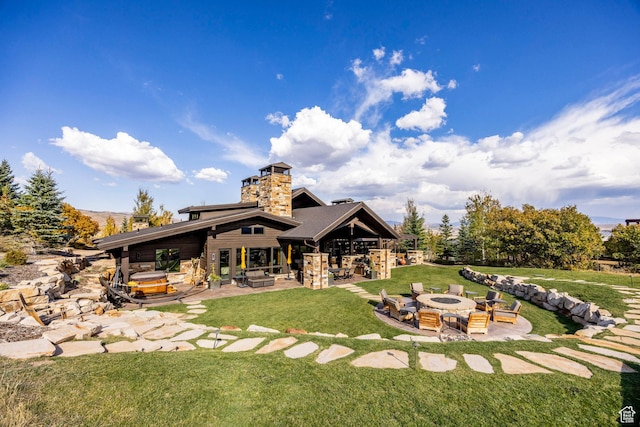 1159 Snow Berry St, Park City, UT 84098 - back of property featuring an outdoor fire pit, a patio, a chimney, and a lawn