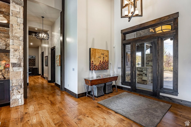 1159 Snow Berry St, Park City, UT 84098 - foyer featuring a towering ceiling, a notable chandelier, hardwood / wood-style floors, and baseboards