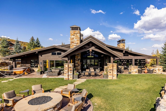 1159 Snow Berry St, Park City, UT 84098 - rear view of property featuring an outdoor fire pit, a chimney, a patio, and stone siding