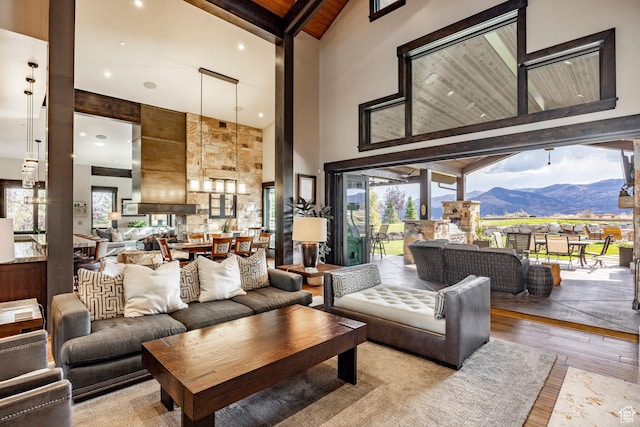 1159 Snow Berry St, Park City, UT 84098 - living area featuring beam ceiling, high vaulted ceiling, a mountain view, and wood finished floors