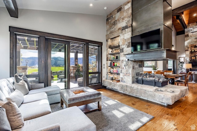 1159 Snow Berry St, Park City, UT 84098 - living room with beamed ceiling, hardwood / wood-style floors, a fireplace, and a healthy amount of sunlight