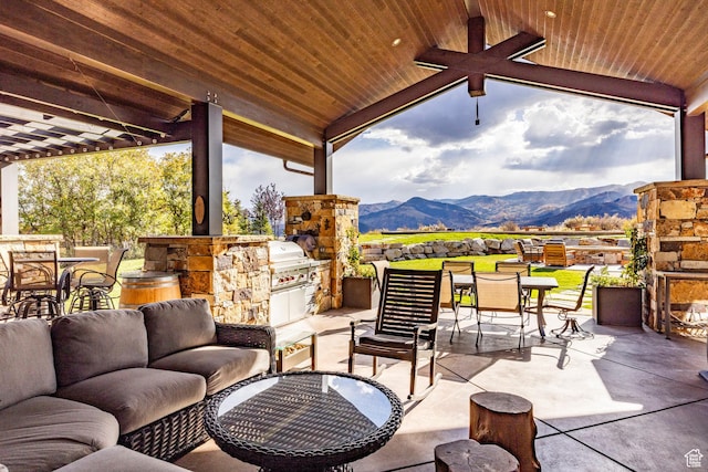 1159 Snow Berry St, Park City, UT 84098 - view of patio featuring an outdoor kitchen, outdoor dining space, area for grilling, a mountain view, and an outdoor living space with a fireplace
