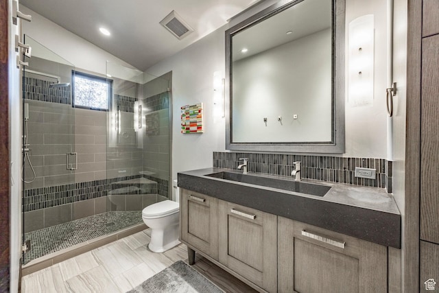 1159 Snow Berry St, Park City, UT 84098 - bathroom featuring a stall shower, toilet, visible vents, vanity, and decorative backsplash